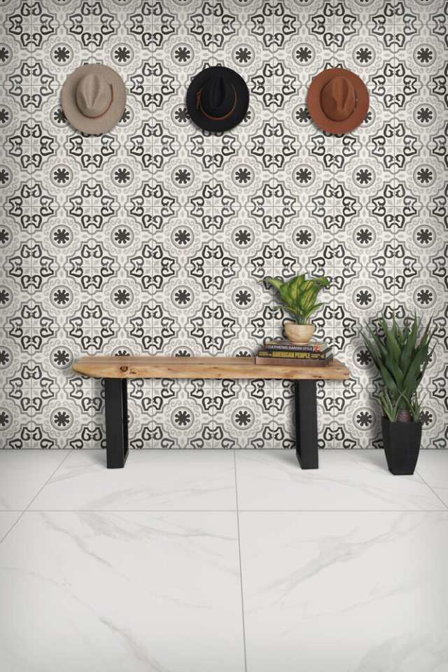 black and white mosaic accent wall in entryway with wooden bench and marble floors